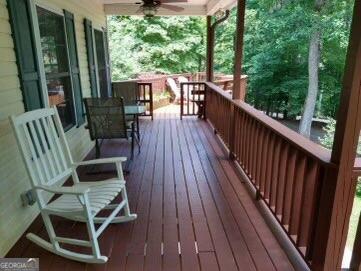 wooden deck featuring ceiling fan