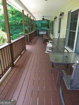 deck with covered porch and ceiling fan