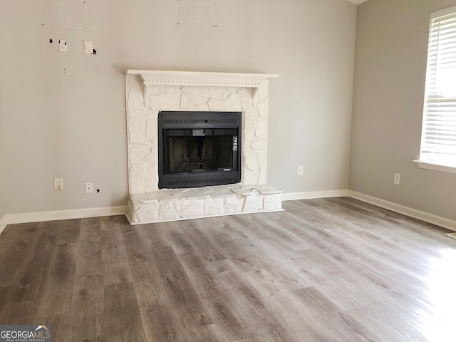 unfurnished living room featuring a fireplace and hardwood / wood-style flooring