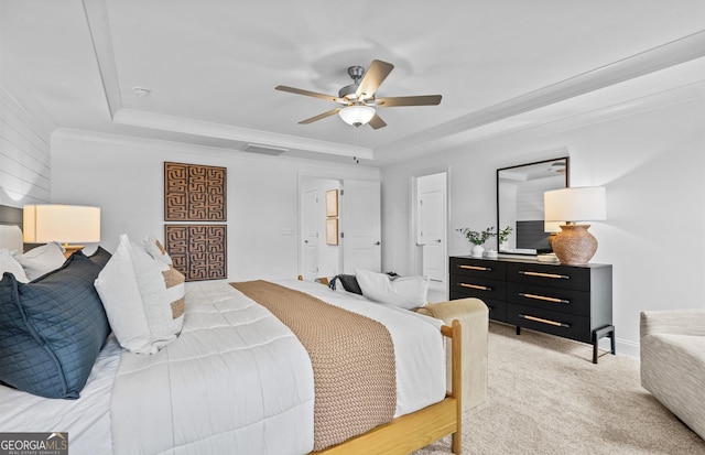 carpeted bedroom featuring a raised ceiling and ceiling fan