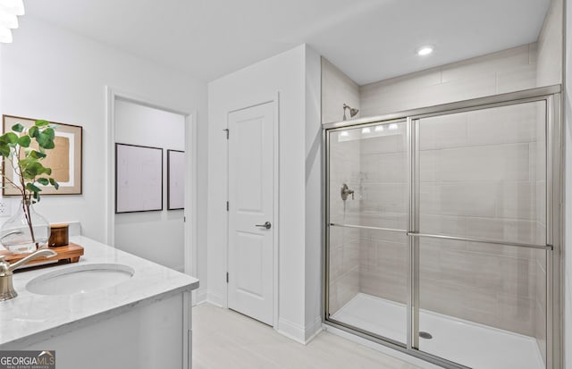 bathroom featuring vanity, tile patterned floors, and a shower with door