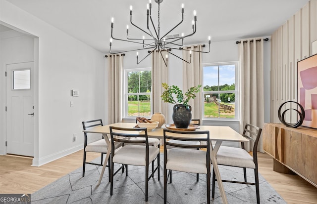 dining area with a chandelier and light wood-type flooring