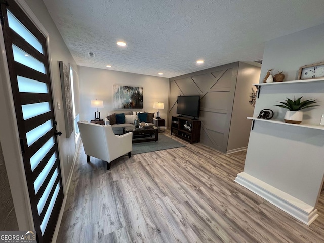 living room featuring a textured ceiling and hardwood / wood-style flooring