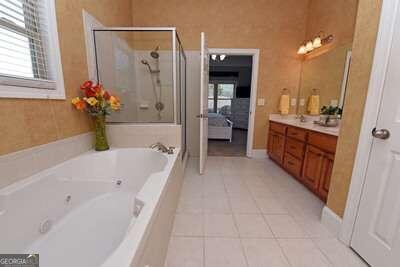 bathroom with vanity, shower with separate bathtub, and tile patterned floors