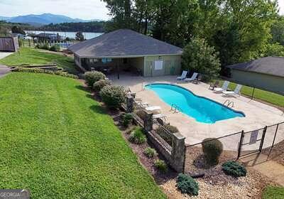 view of pool featuring a patio and a yard