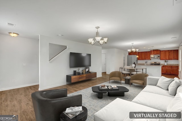 living room featuring hardwood / wood-style flooring and a chandelier