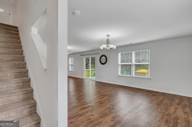 interior space with dark hardwood / wood-style flooring and an inviting chandelier