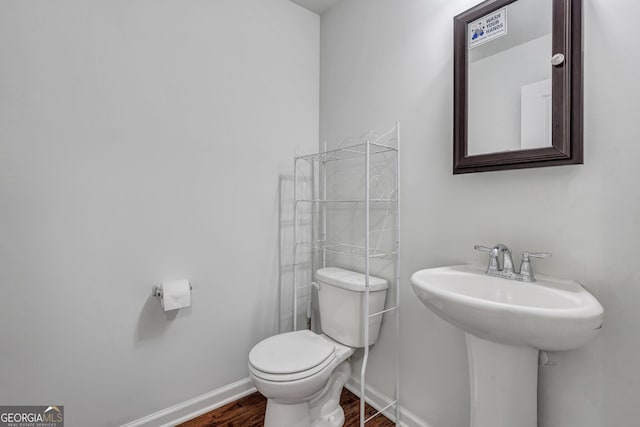 bathroom featuring hardwood / wood-style flooring, sink, and toilet