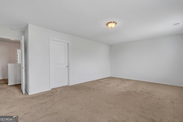 unfurnished room featuring light colored carpet