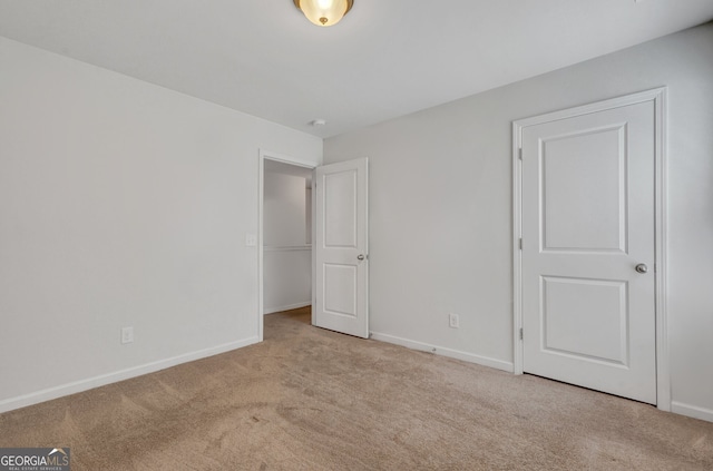 unfurnished bedroom featuring light carpet