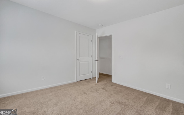 unfurnished room with light colored carpet