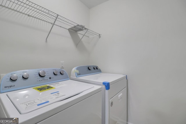 clothes washing area featuring washer and dryer