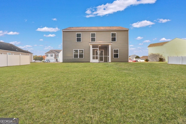 back of house featuring a sunroom and a yard