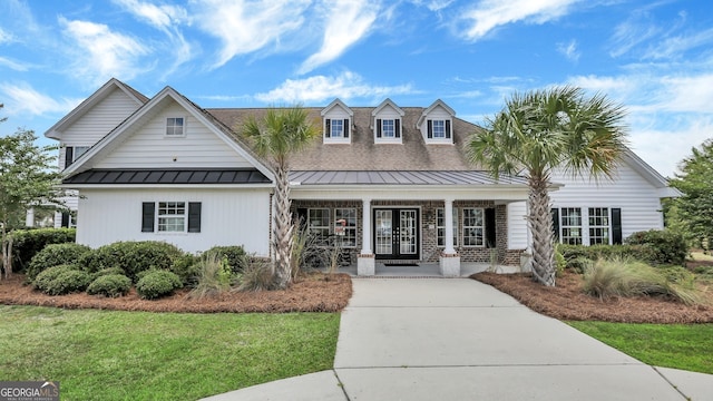 view of front of home featuring covered porch and a front lawn