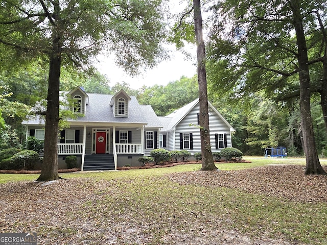 cape cod house featuring a porch and a front lawn