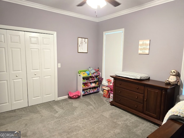 bedroom with ceiling fan, a closet, light carpet, and crown molding