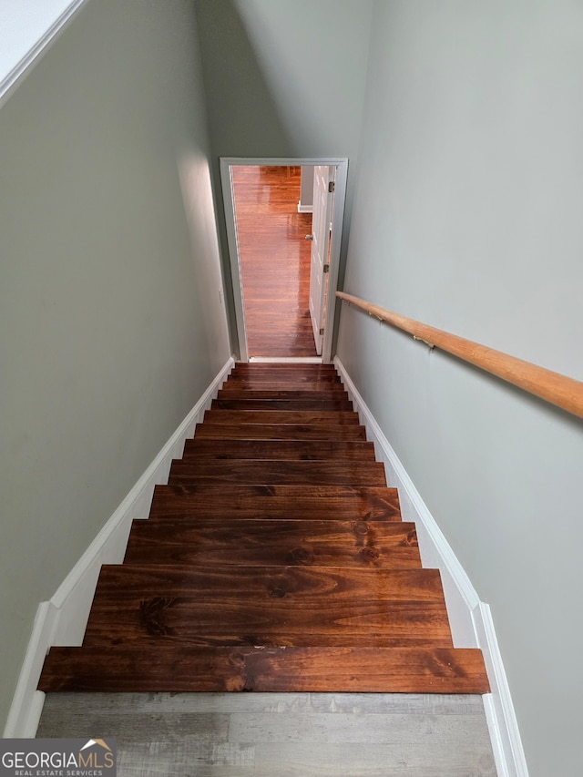 stairway featuring hardwood / wood-style floors