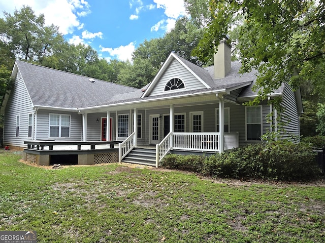 view of front of home with covered porch and a front yard