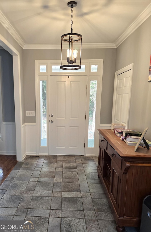 1080 Julian St, Bartow, GA 30413 - foyer entrance with a wainscoted wall, an inviting chandelier, and crown molding