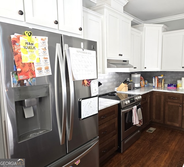 kitchen featuring ornamental molding, backsplash, white cabinetry, stainless steel appliances, and dark hardwood / wood-style floors