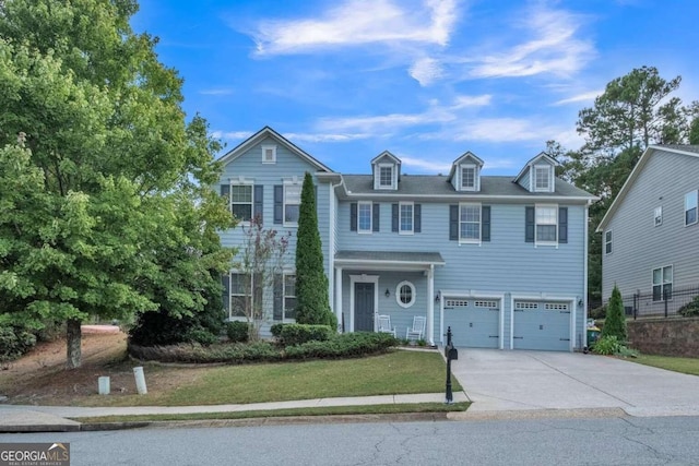 colonial home with a garage and a front lawn