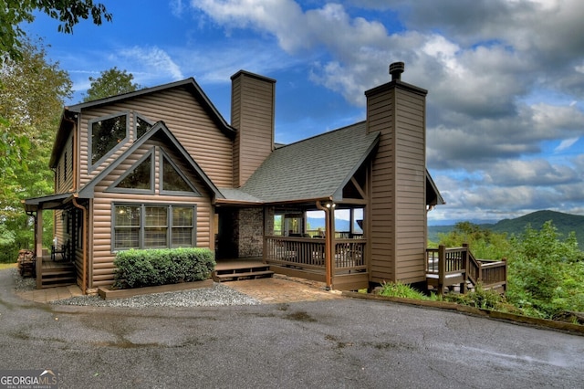 log home featuring a deck with mountain view