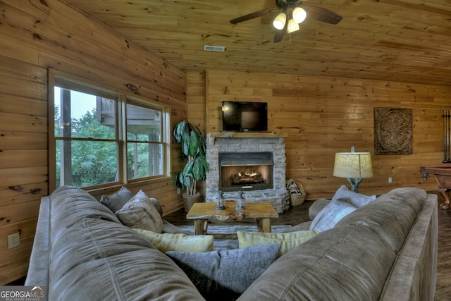 living room featuring ceiling fan, a fireplace, hardwood / wood-style floors, and a healthy amount of sunlight