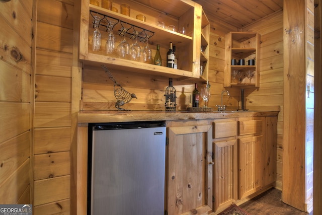 full bathroom featuring vanity, wooden walls, shower / bath combo with shower curtain, and toilet