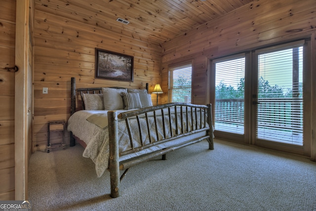 carpeted bedroom featuring wooden ceiling, wood walls, and ceiling fan