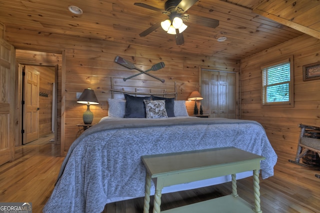 dining area featuring light hardwood / wood-style flooring, wood ceiling, and wooden walls