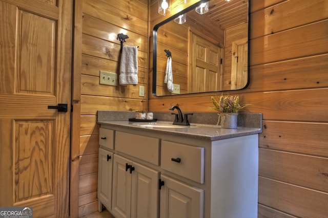 laundry room with wooden walls and washing machine and clothes dryer