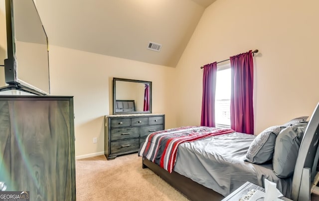 bedroom featuring lofted ceiling and light colored carpet