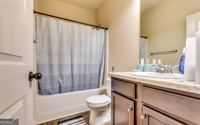 full bathroom featuring vanity, shower / bath combination with curtain, wood-type flooring, and toilet