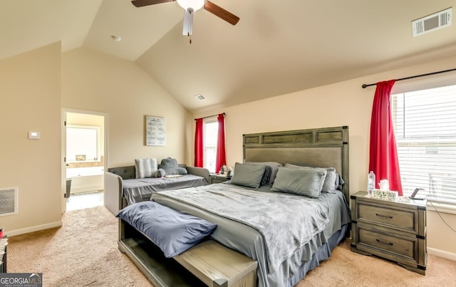 bedroom with ceiling fan, light carpet, lofted ceiling, and ensuite bath