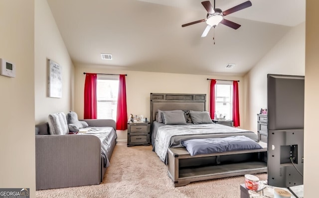 bedroom featuring ceiling fan, multiple windows, lofted ceiling, and light carpet