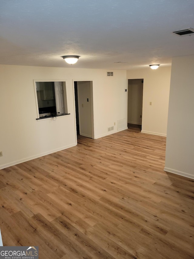 empty room with light hardwood / wood-style flooring