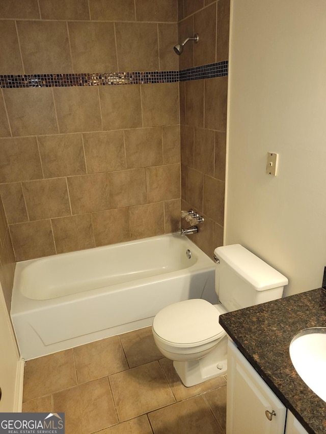 full bathroom with toilet, tile patterned flooring, tiled shower / bath combo, and vanity