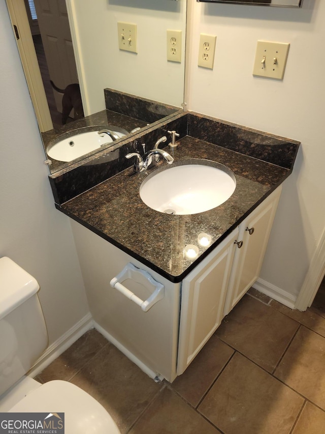 bathroom featuring tile patterned floors, toilet, and vanity