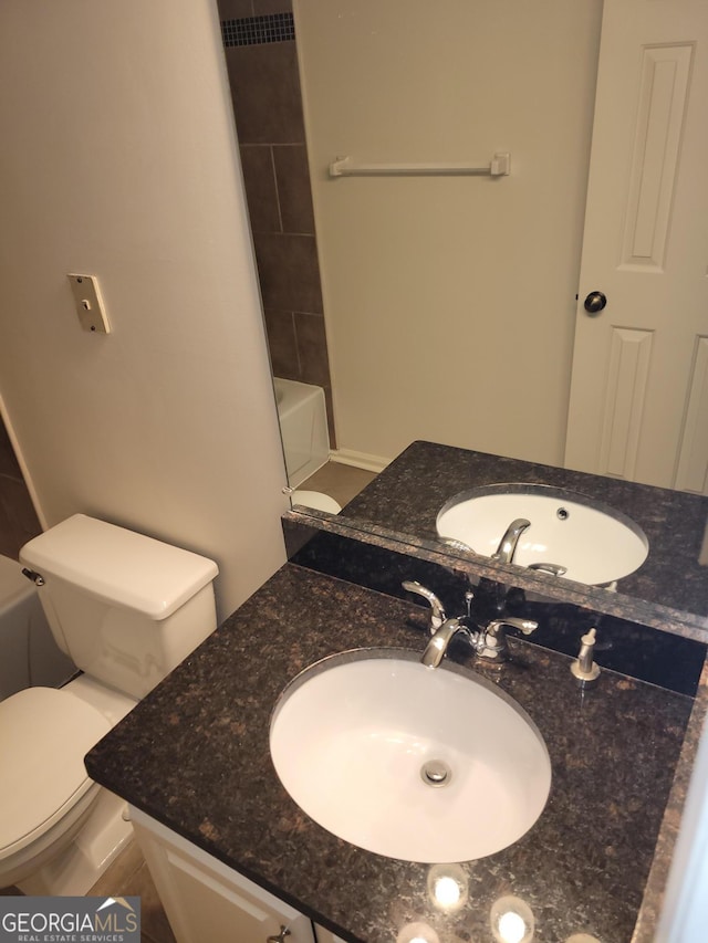 bathroom featuring toilet and vanity