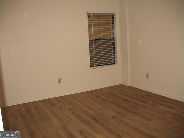 spare room with dark hardwood / wood-style floors