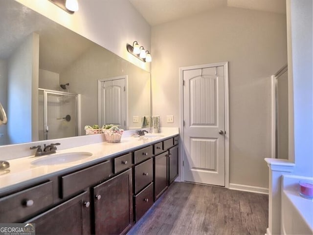 bathroom with vanity, an enclosed shower, vaulted ceiling, and hardwood / wood-style flooring