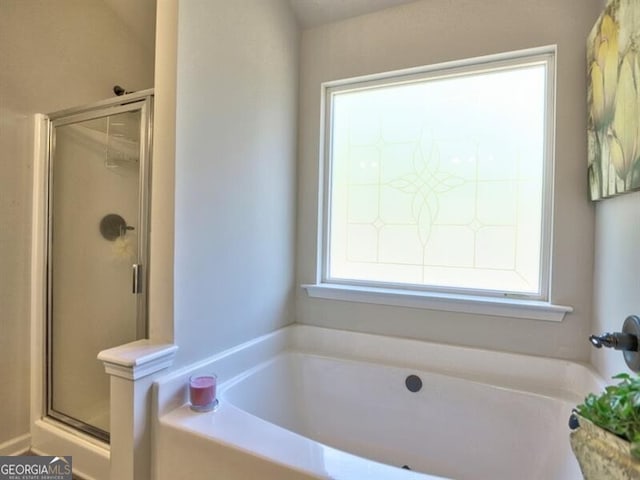 bathroom with plus walk in shower and a wealth of natural light