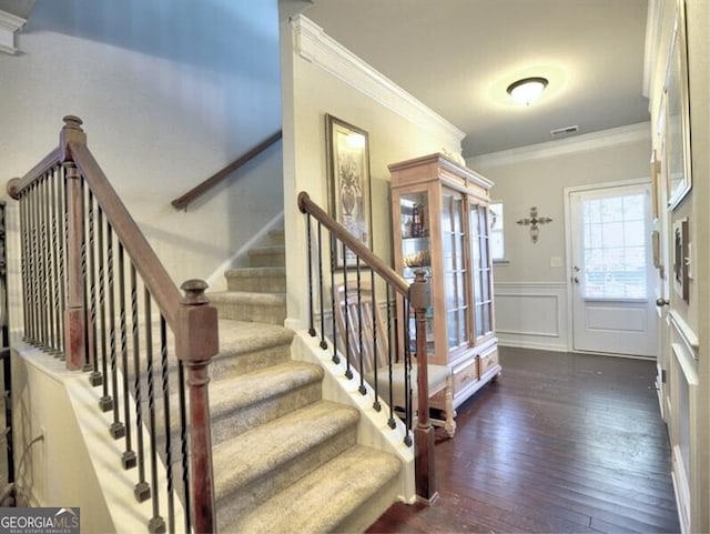 stairway featuring hardwood / wood-style flooring and ornamental molding