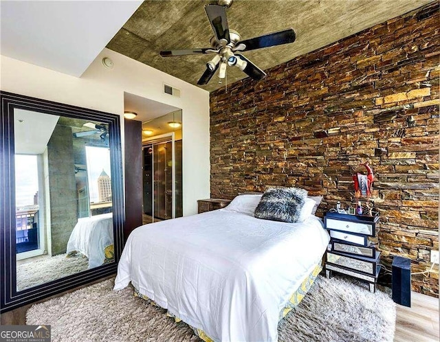 bedroom with ceiling fan and hardwood / wood-style flooring