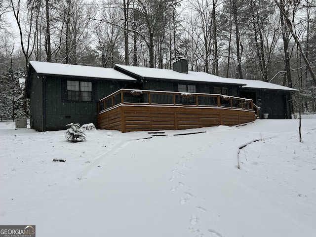 view of snow covered back of property