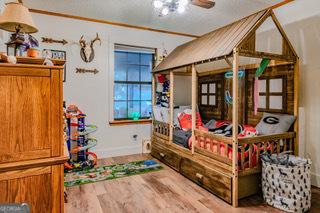 bedroom featuring baseboards and wood finished floors