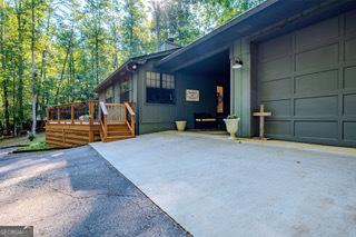 ranch-style home featuring a wooden deck and a garage