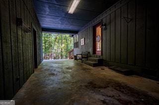 interior space featuring board and batten siding and entry steps