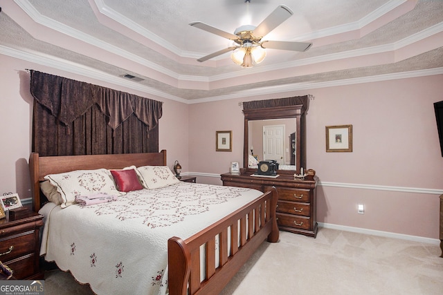 bedroom featuring a tray ceiling, ceiling fan, and crown molding