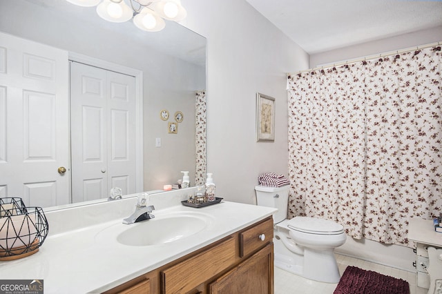 full bathroom with vanity, shower / bath combo with shower curtain, toilet, and tile patterned floors